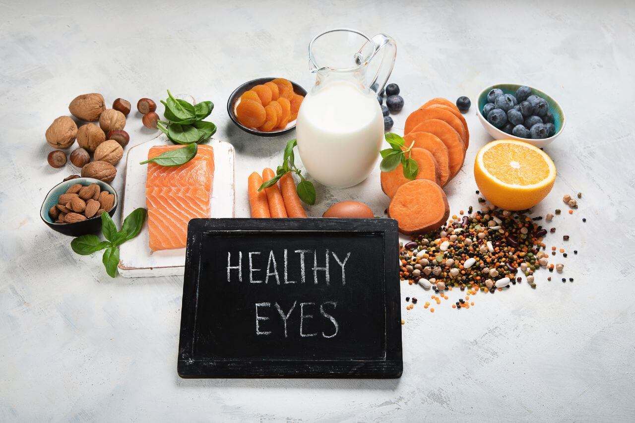 Fruits with a black board with healthy eyes written in chalk