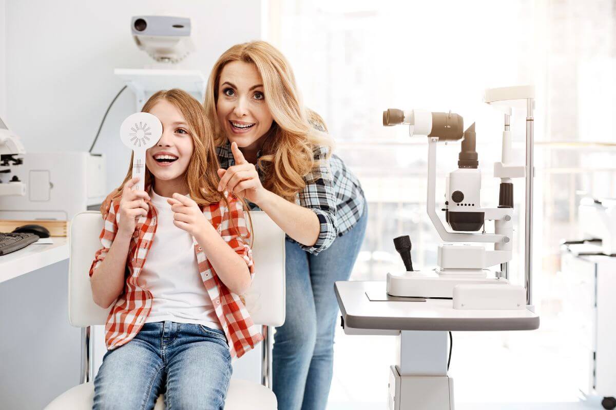 Image of a young girl with a woman in an optometrist chair